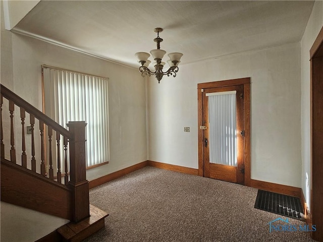 entryway featuring carpet flooring and a notable chandelier