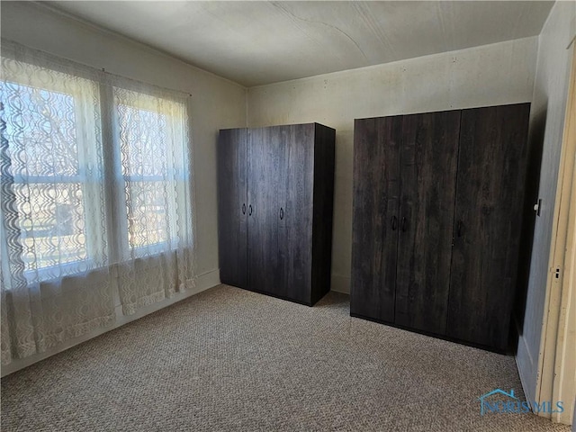 unfurnished bedroom featuring light colored carpet