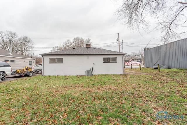 exterior space with a lawn and central AC