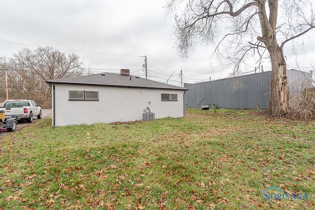 exterior space featuring a lawn and central AC unit