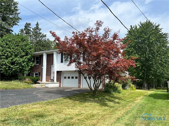 view of front of house with a front yard and a garage