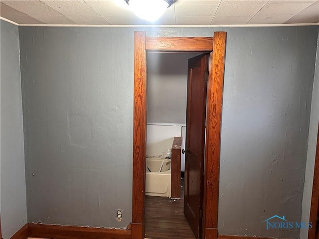 corridor with hardwood / wood-style flooring