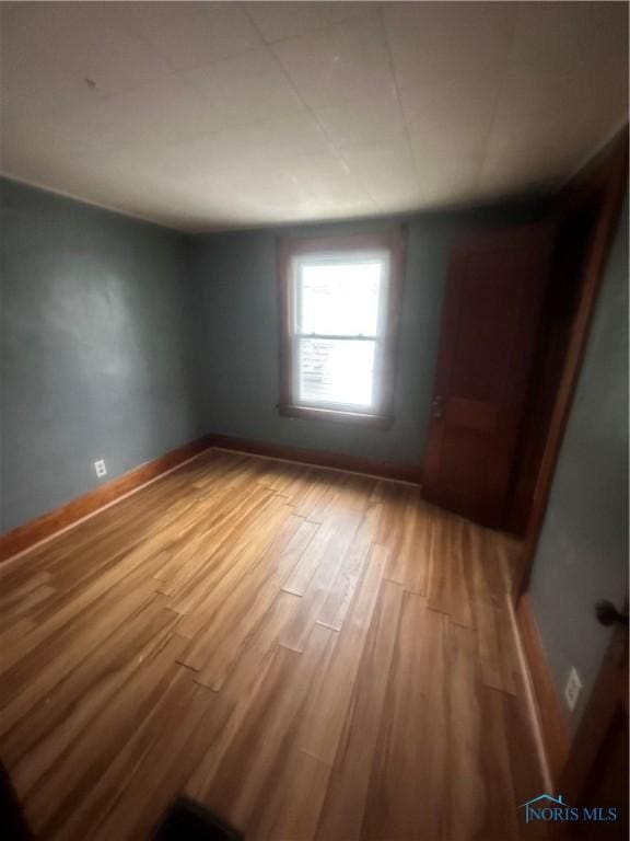 unfurnished room featuring wood-type flooring