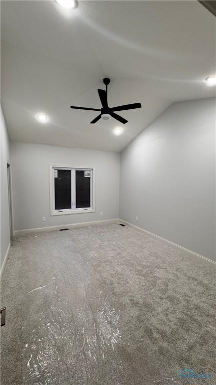 spare room with lofted ceiling and ceiling fan