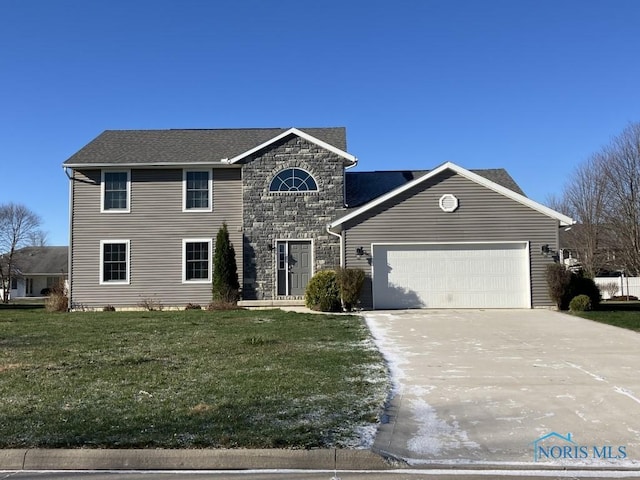 view of front of home featuring a garage and a front lawn