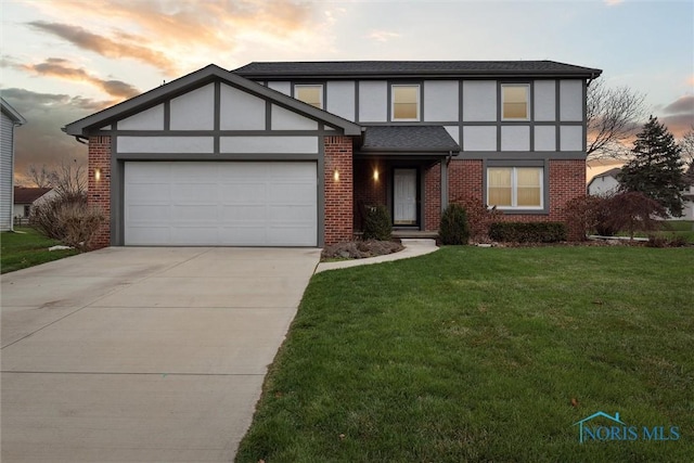 view of front facade with a garage and a yard