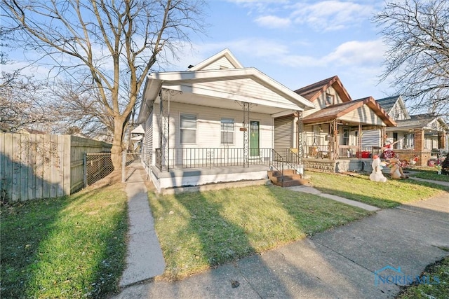 bungalow featuring a porch and a front yard