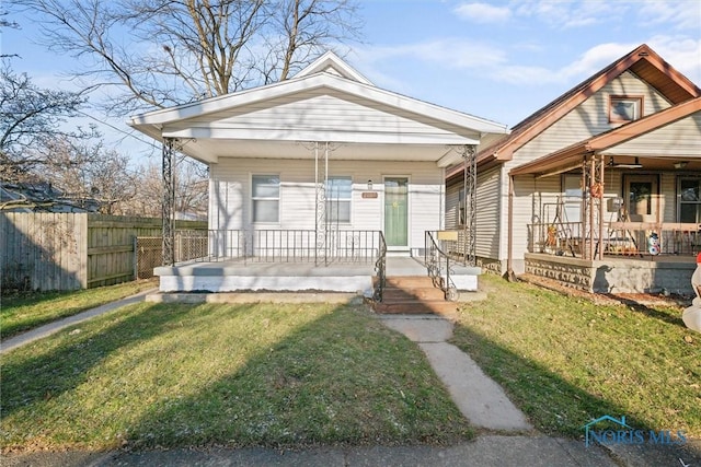 bungalow-style house featuring a porch and a front lawn