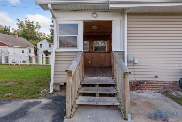 property entrance with a yard