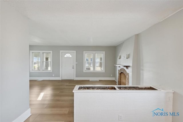 foyer with hardwood / wood-style floors and a textured ceiling