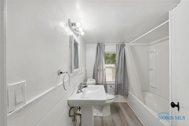 bathroom with toilet, shower / tub combo, and hardwood / wood-style flooring