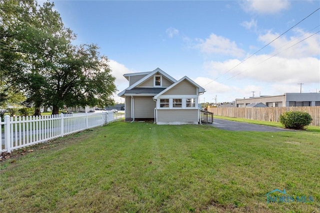 rear view of house featuring a lawn