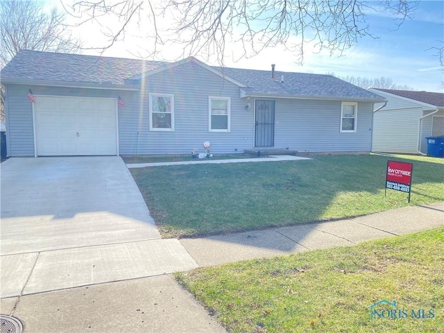 single story home with a garage and a front lawn