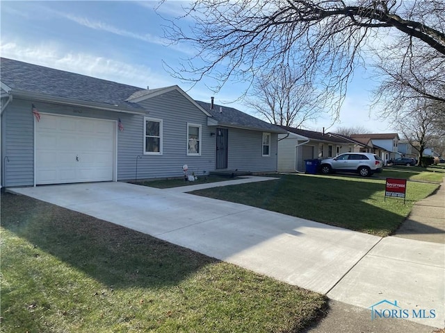 ranch-style home with a front yard and a garage