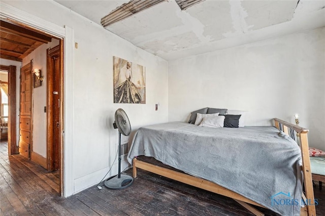 bedroom with dark hardwood / wood-style floors