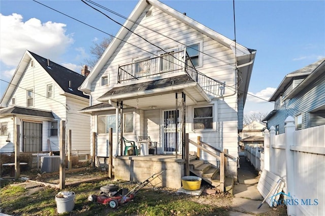 rear view of property with a balcony and central AC