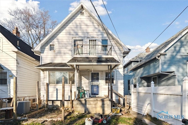 back of house featuring central AC and a balcony