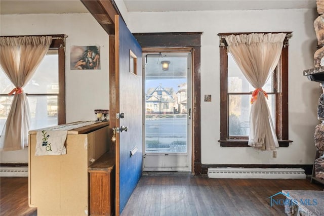 entryway with a healthy amount of sunlight, dark wood-type flooring, and a baseboard heating unit