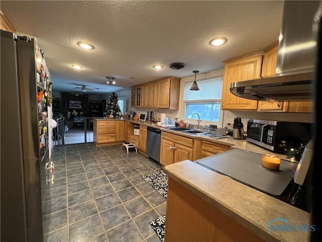 kitchen with ceiling fan, pendant lighting, a textured ceiling, and appliances with stainless steel finishes