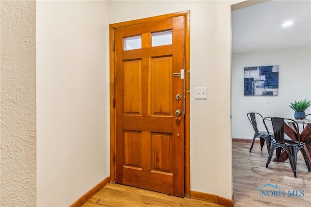 foyer entrance with light hardwood / wood-style floors