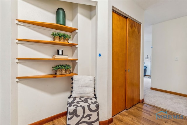 corridor with light hardwood / wood-style floors