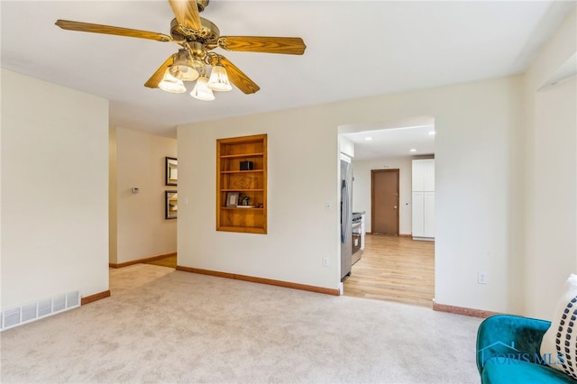 interior space featuring ceiling fan and built in features