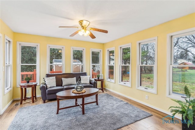 sunroom featuring ceiling fan