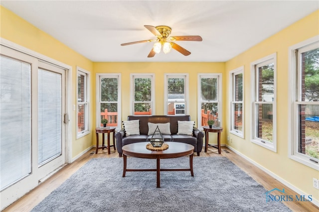 sunroom / solarium featuring a wealth of natural light and ceiling fan