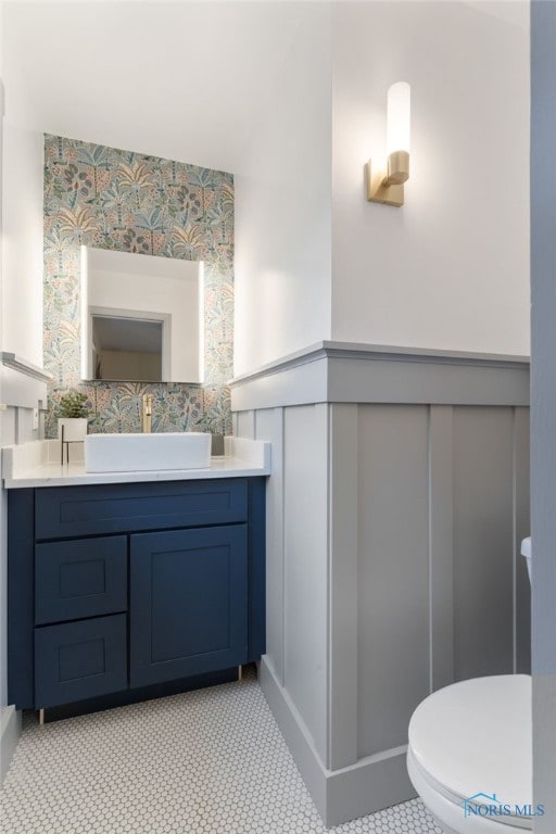 bathroom featuring tile patterned floors, vanity, and toilet