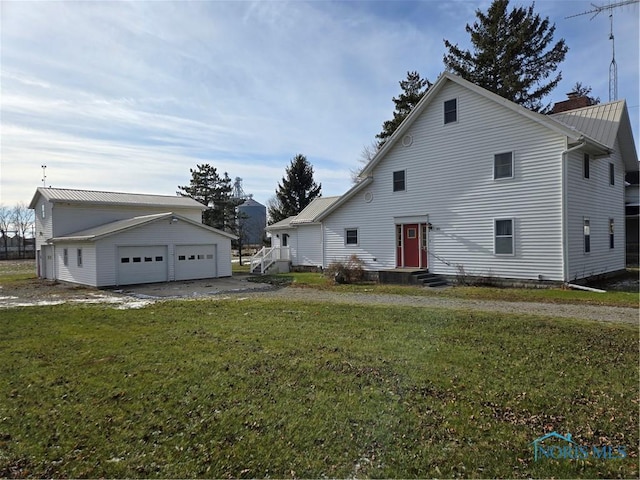 exterior space with a yard, a garage, and an outdoor structure