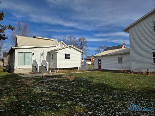 back of house featuring a lawn