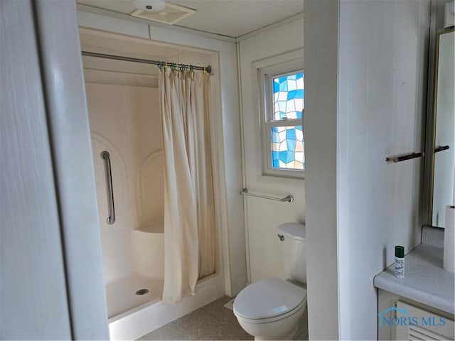 bathroom with a shower with curtain and toilet