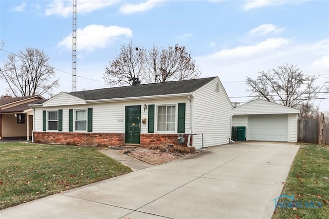 view of front of home with a front yard, a garage, and an outdoor structure