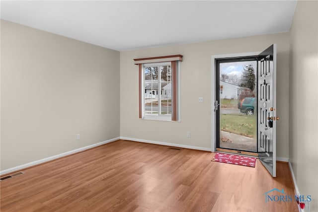 entryway with light hardwood / wood-style floors