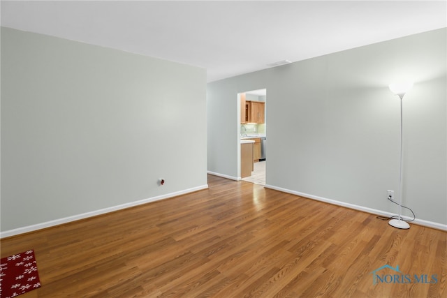 spare room featuring light wood-type flooring