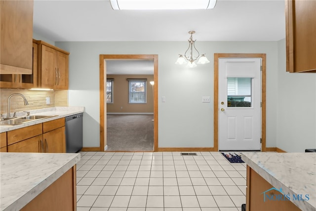 kitchen with pendant lighting, sink, stainless steel dishwasher, a notable chandelier, and light colored carpet