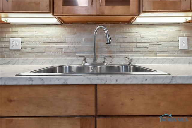 kitchen featuring sink and tasteful backsplash