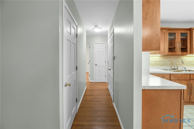 corridor featuring dark hardwood / wood-style flooring and sink