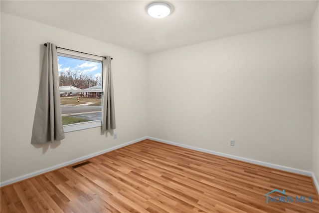 unfurnished room with light hardwood / wood-style flooring