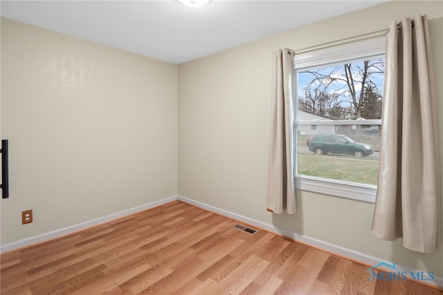 spare room featuring light hardwood / wood-style flooring