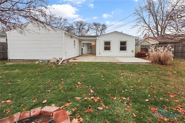 rear view of property featuring a patio and a lawn