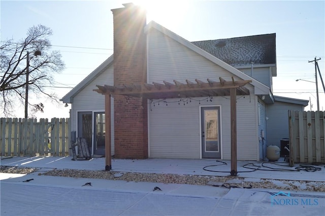 rear view of house with a pergola