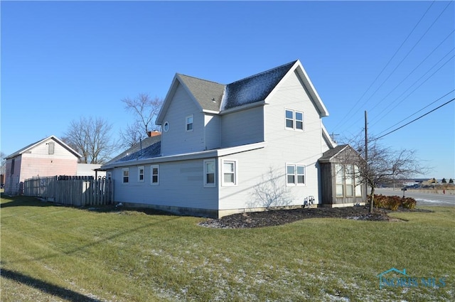 view of property exterior with a yard