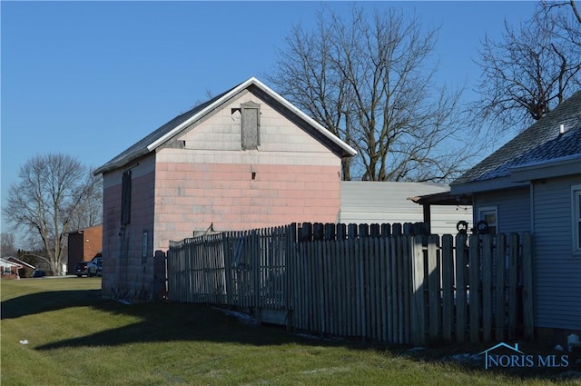 view of side of property with a yard