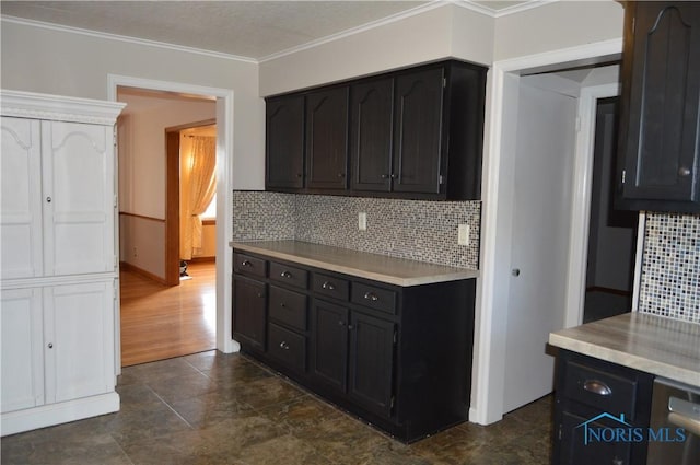 kitchen featuring dishwasher, dark wood-type flooring, crown molding, and tasteful backsplash