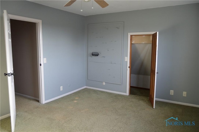 unfurnished bedroom with ceiling fan and light colored carpet