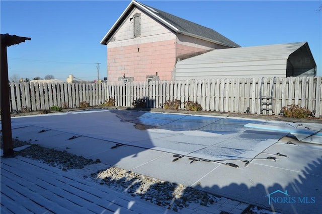 view of pool with a diving board