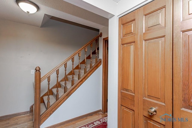 stairway featuring hardwood / wood-style flooring