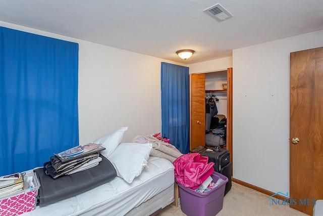 carpeted bedroom with a closet