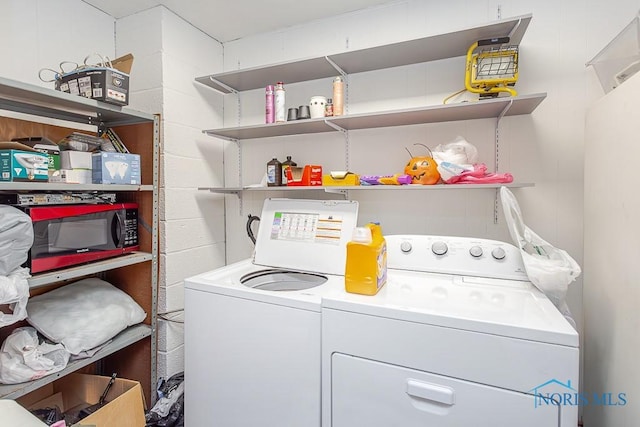 clothes washing area featuring independent washer and dryer